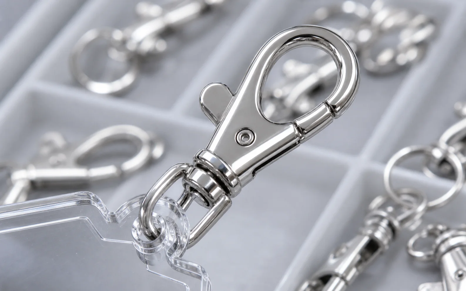 Close-up of a metal lobster clasp attached to an acrylic keychain